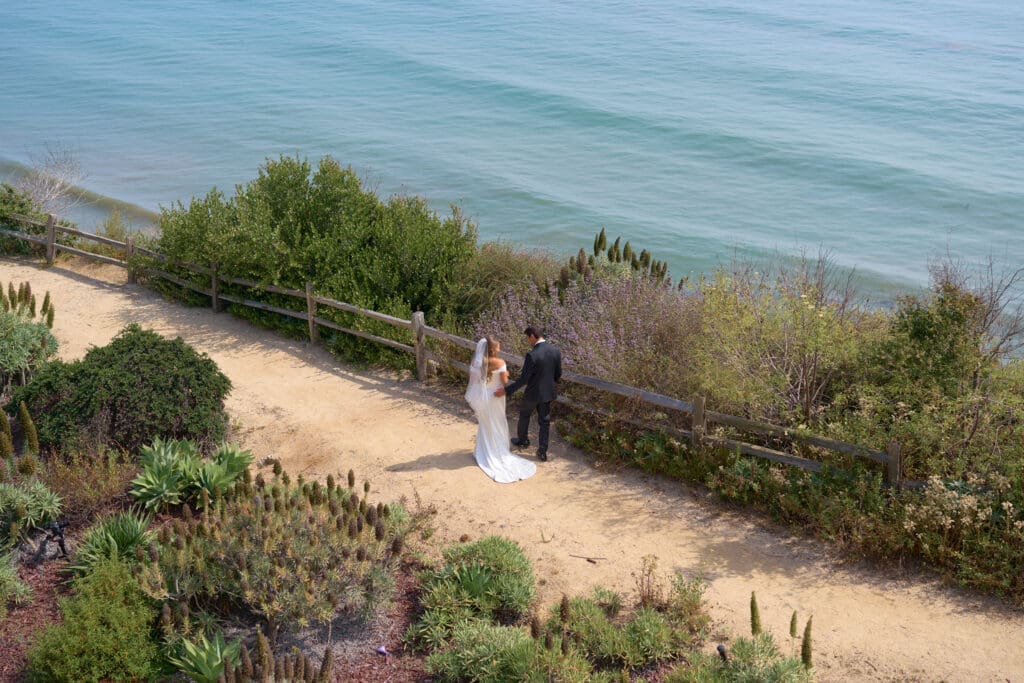 Bride and groom first look on their wedding day overlooking the Pacific Ocean.